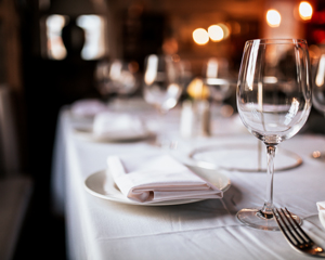 elegantly set dining table with wine glasses and neatly folded napkins creating a sophisticated atmosphere